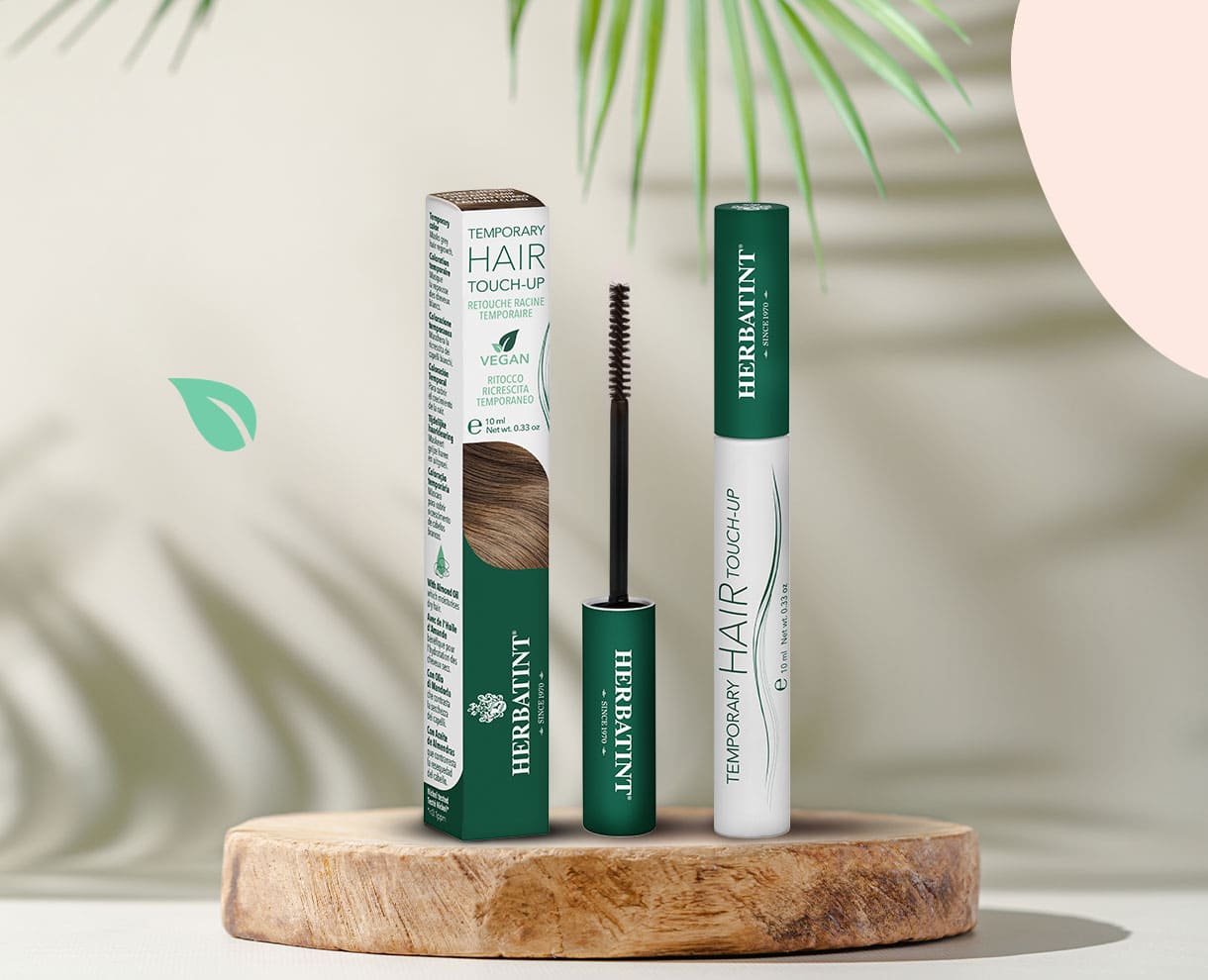 Herbatint Temporary Hair Touch-Up product voor het bijwerken van de haaraanzet, met flesje en verpakking zichtbaar op houten standaard, natuurlijke decoratie op de achtergrond