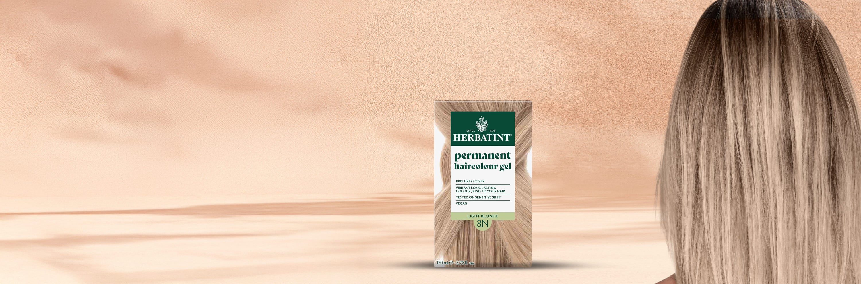 Herbatint 8N light blonde permanent coloring gel box beside a woman’s smooth glossy hair in a natural blonde shade