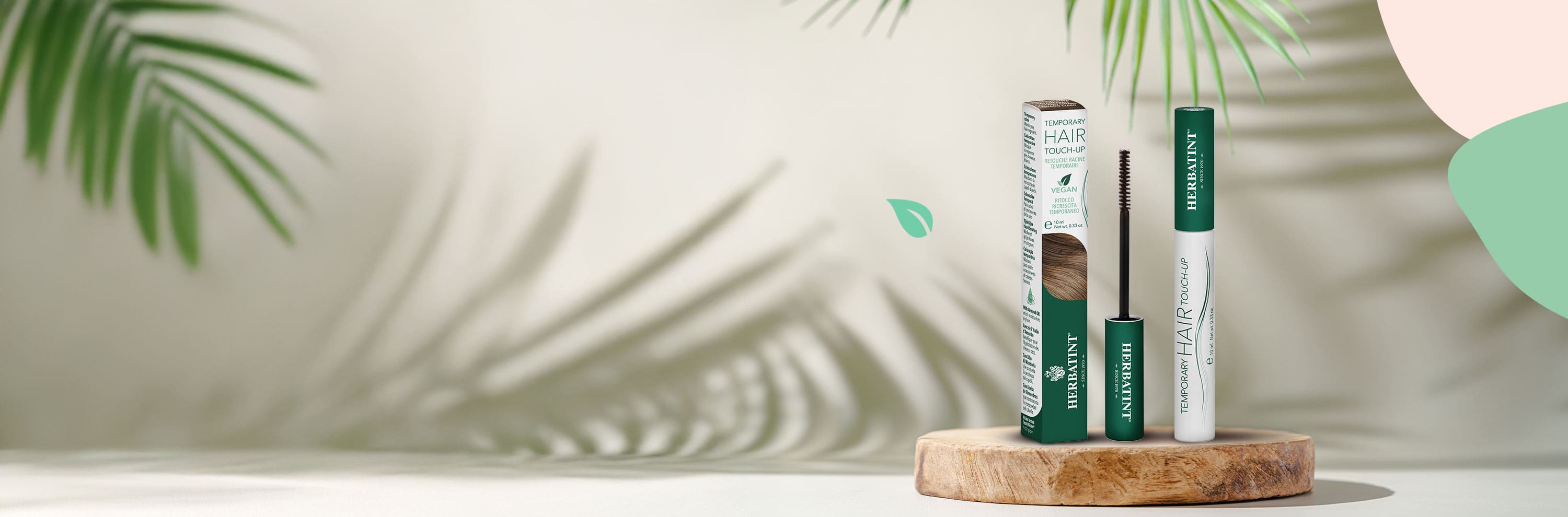 Herbatint Temporary Hair Touch-Up product displayed on a wooden surface, featuring the mascara applicator and blonde shade packaging; natural background with leaves and organic shapes