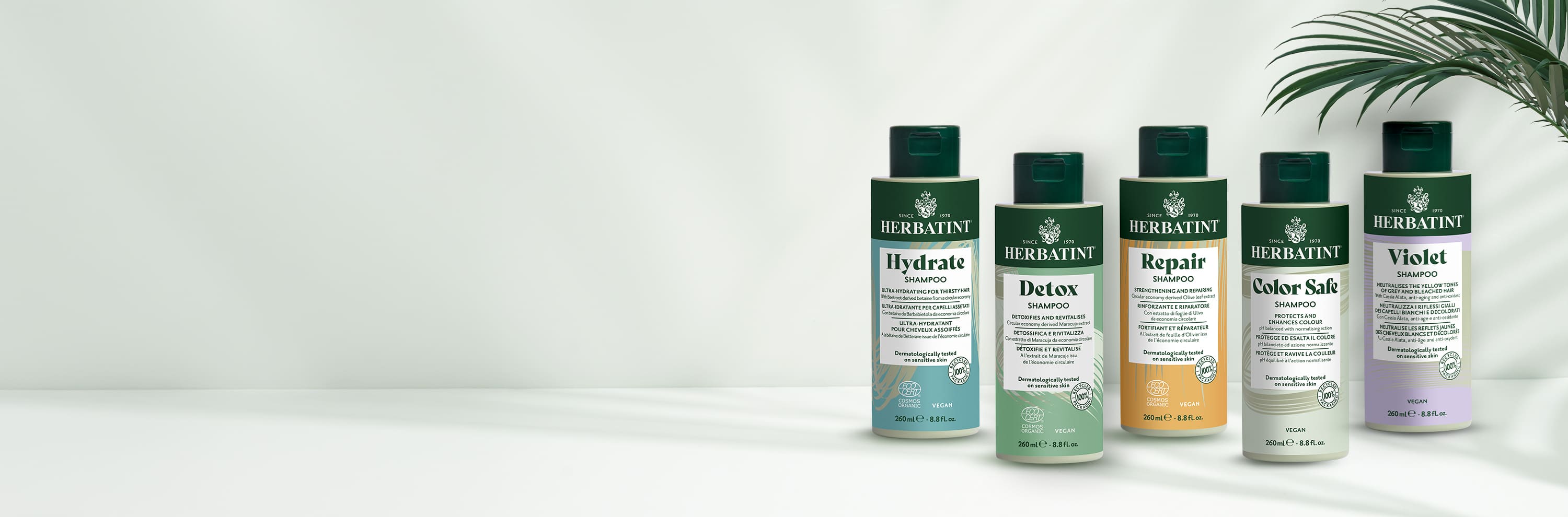 Five Herbatint shampoo bottles for sensitive skin and scalp – Hydrate, Detox, Repair, Color Safe and Violet variants on a light background